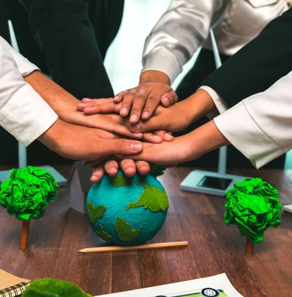 Group of business people put hand stack showing synergy of corporate cooperation on environmental protection to save Earth. Environmental awareness and eco unity concept. Trailblazing